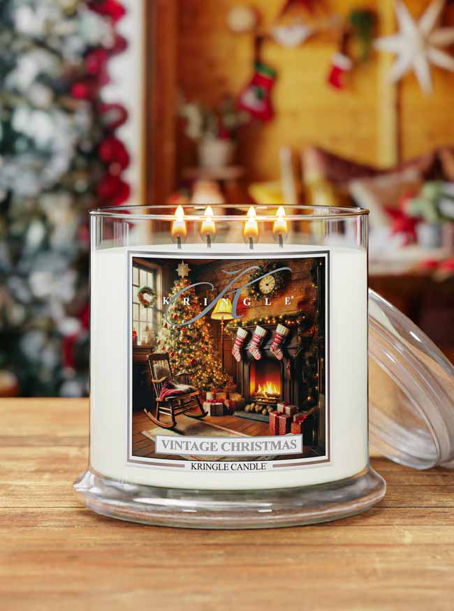 Kringle Candle with a Christmas scene label on a wooden surface, with a festive background.