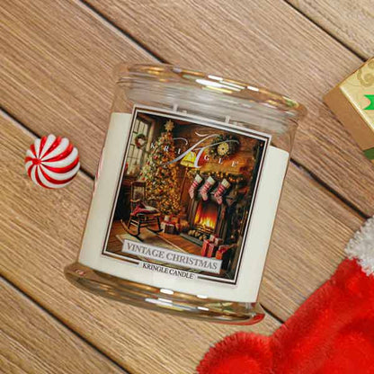 Vintage Christmas Kringle Candle on a wooden surface with a peppermint candy and Santa hat.