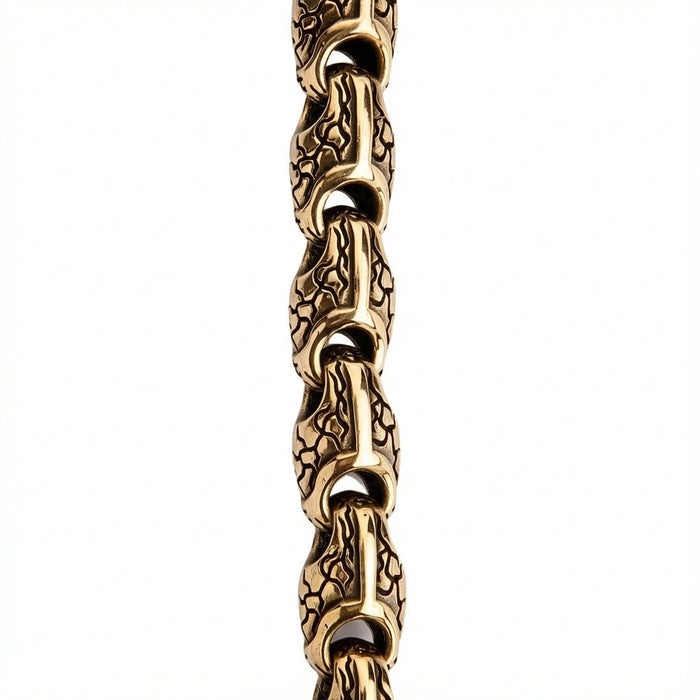 Macro detail of intricate snake scale texture on brass chain links