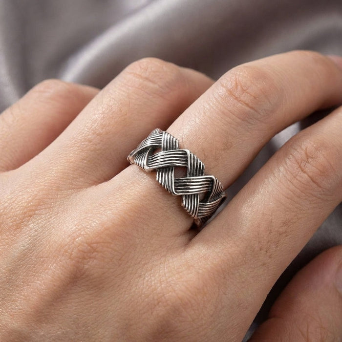 Wave knot sterling silver ring worn on finger demonstrating 10mm band width and comfortable fit