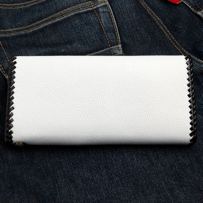 The back of the white cowhide wallet, showing its clean look and black braided edge.