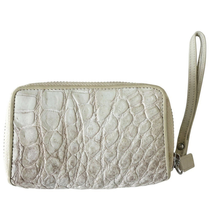 Close-up of the genuine crocodile hide texture and pearlescent finish on a white zip wallet with attached wristlet strap.