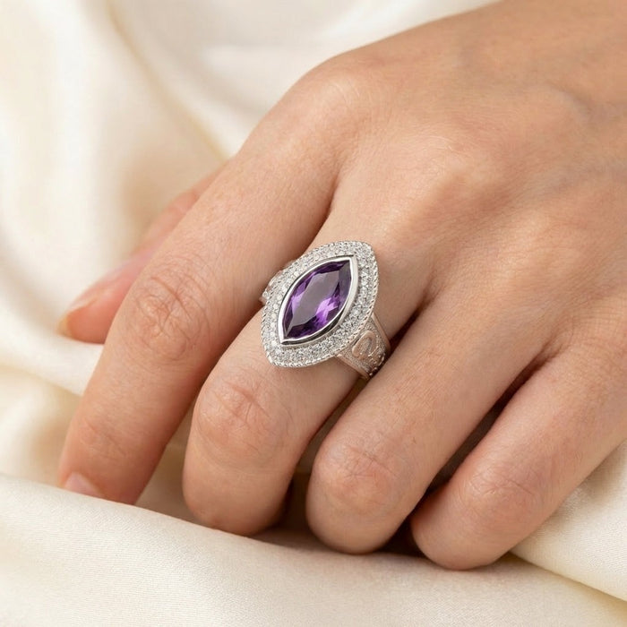 Women's sterling silver bishop ring with marquise amethyst worn on hand showing scale and elegant fit
