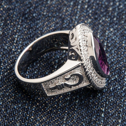 Left side view of women's bishop ring displaying oxidized crosier symbol and stippled silver texture