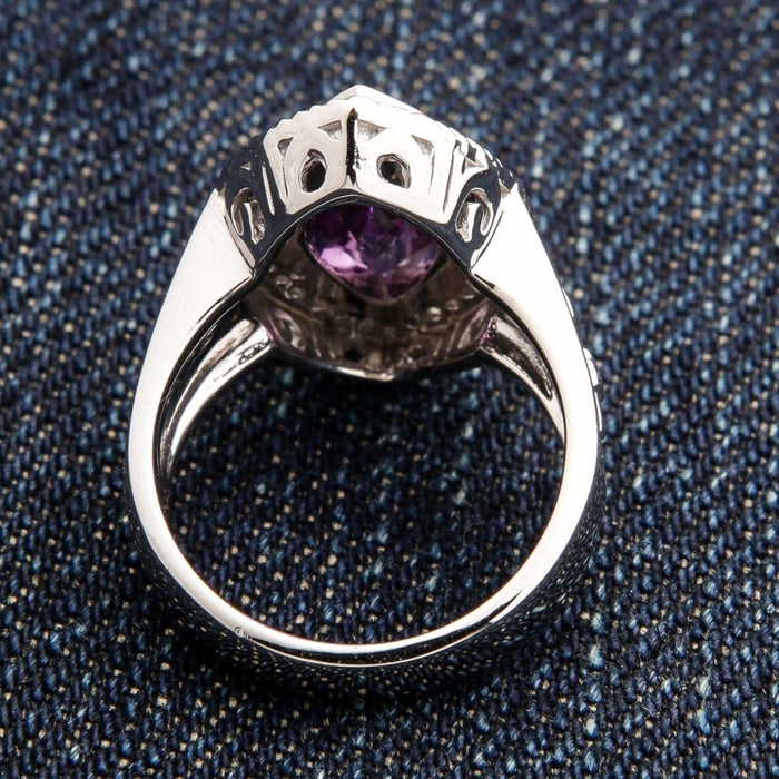 Underside view of women's sterling silver bishop ring showing filigree openwork and amethyst visible through setting